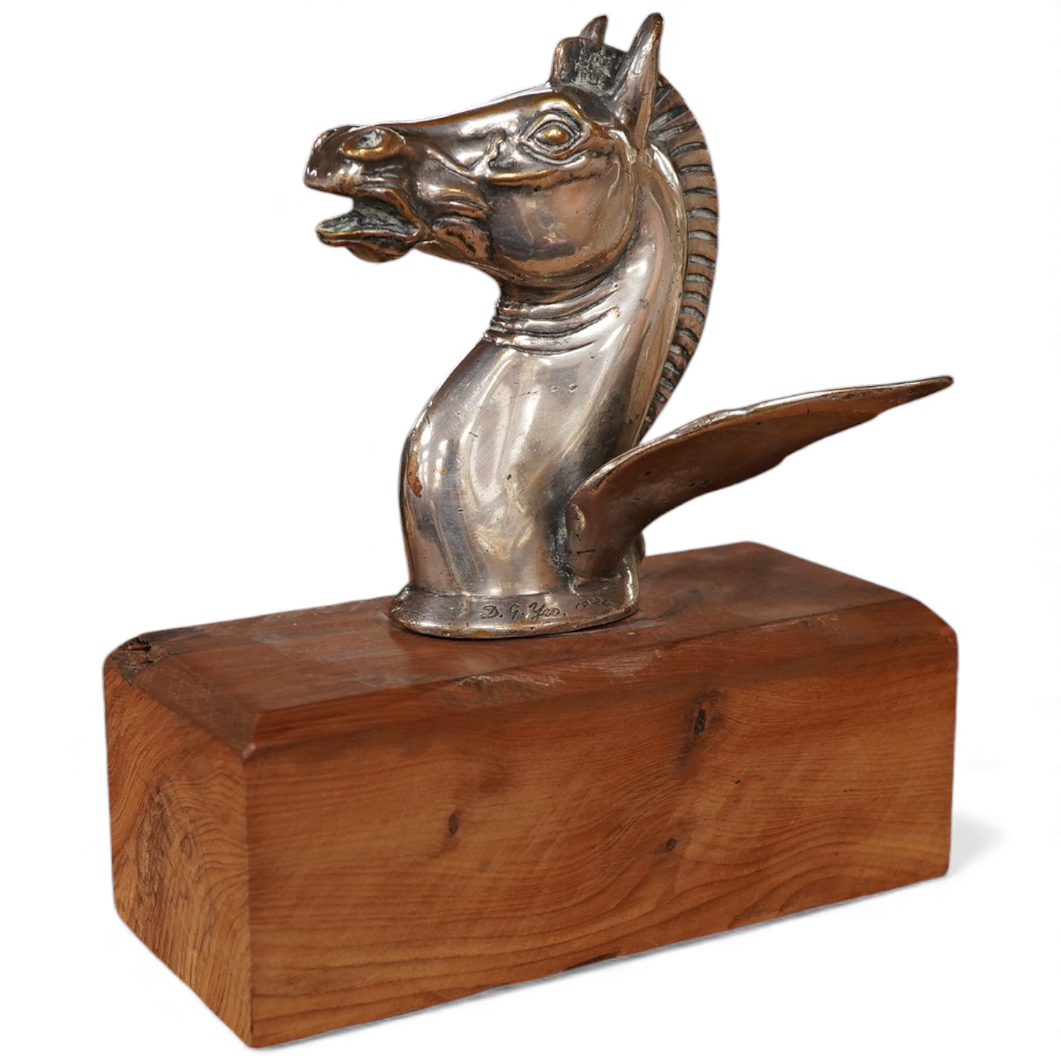A silver plated Pegasus horse's head car mascot, signed D.G. Yeo, dated 1924, mounted on a wooden plinth